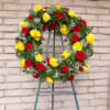 Circular wreath of red and yellow roses on a stand