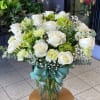 White roses, green hydrangeas, pale green carnations, white alstroemeria, baby's breath and