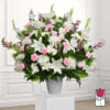 Large white and pink floral arrangement in a gray vase