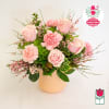 Pink roses and carnations arranged in a pale vase