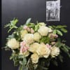 Cream and pink rose bouquet in a glass vase with greenery