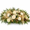 Holiday floral arrangement with white roses, carnations, and gold accents