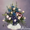 Football-themed floral arrangement with blue and white flowers in a vase