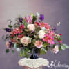 Pink and white floral arrangement in a black vase