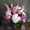 Pink and purple mixed bouquet in a glass vase