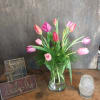 Pink and purple tulips in a clear glass vase