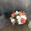 Bouquet of orange and white roses with white hydrangeas in a vase