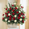 Red carnations and white carnations are accented with white monte casino in