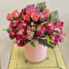 Pink and magenta bouquet in a pale pink vase