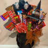 Halloween candy bouquet in a black skull vase with witch hats and ribbon