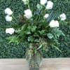 White roses arranged in a clear glass vase