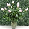 Pink roses arranged in a clear glass vase