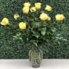 Yellow roses arranged in a clear glass vase