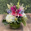 Pink lilies and hydrangeas in a green vase
