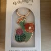 Enamel cactus keychain in a retail box