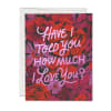 Romantic greeting card with pink script text over a red and purple floral background