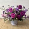 A fun combination of purples and lavenders, in a ceramic compote vase.