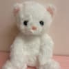 White plush teddy bear with pink ears and nose