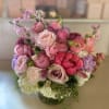 Pink and lavender bouquet of mixed flowers in a glass vase