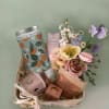 Gift basket with flowers, bath items, and a ribbon bow