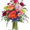 A lively mix of pink, orange, purple, and white blooms creates an