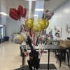 Cluster of helium balloons on sticks in a display stand