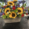 Sunflower arrangement with purple and red flowers in a rectangular wooden planter