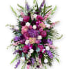 Large standing spray of pink, purple, and white flowers on an easel