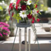 Red roses and white daisies in a hanging wind chime arrangement