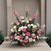Large basket arrangement of pink roses, carnations, and white daisies