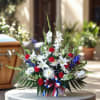 Red, white, and blue floral arrangement with a ribbon bow