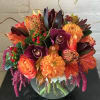 Orchids, dahlias, roses, and protea come together to create a bountiful bowl