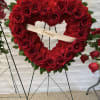 Heart-shaped red rose and carnation wreath with a ribbon reading Daddy
