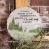 Memorial stone with hunting-themed text and pine tree relief