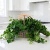 Basket of trailing ivy with a straw bow on a kitchen counter