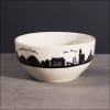White ceramic bowl with a black city skyline and landmark names around the rim.