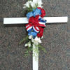 Floral cross with red, white, and blue flowers and ribbon
