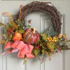 Fall Pumpkin Grapevine wreath with artificial flowers.