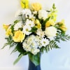 Yellow and white flowers arranged in a blue vase