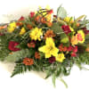 Mixed bouquet with yellow lilies, red roses, and orange daisies