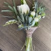 Boutonniere with a white rose and blue-green foliage