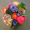 Colorful bouquet with roses, hydrangea, and purple blooms