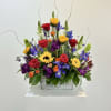 Honor a life beautifully lived with this vibrant floral tribute that celebrates
