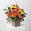Sunflower and orange rose arrangement in a wooden cube vase
