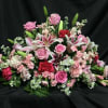 Pink roses and lilies arranged in a low bouquet