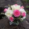 Pink roses and white hydrangeas in a square glass vase