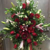 red easel spray with roses gerbs, lilies with white astro and white