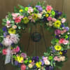 colorful wreath  with roses, daisy, carnation, statice, button poms, and asst