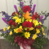 colorful arrangement with lilies, roses, gerbs, daisy. Colors are blue , orange