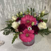 Pink gerbera daisies and white roses in a pink vase